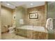 Bright bathroom features a soaking tub with marble tile surround and glass partition at 2000 N Fashion Show Dr # 3921, Las Vegas, NV 89109