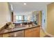 Wet bar with stainless steel fridge, cabinets, and granite countertops overlooking living area at 2000 N Fashion Show Dr # 3921, Las Vegas, NV 89109