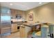Modern kitchen with stainless steel appliances, light wood cabinets, and a cozy bar area at 2000 N Fashion Show Dr # 3921, Las Vegas, NV 89109