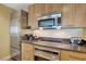 Modern kitchen with stainless steel appliances, light wood cabinets, and a stylish countertop at 2000 N Fashion Show Dr # 3921, Las Vegas, NV 89109