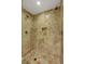 Walk-in shower with built in storage, rainfall shower head, and elegant stone tile at 2000 N Fashion Show Dr # 3921, Las Vegas, NV 89109