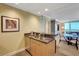 Wet bar with stainless steel fridge, cabinets, and granite countertops overlooking living area at 2000 N Fashion Show Dr # 3921, Las Vegas, NV 89109