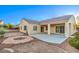 Expansive backyard featuring a covered patio, desert landscaping, and a cozy fire pit area at 2186 Savannah River St, Henderson, NV 89044