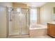 Spacious bathroom features a shower and a separate soaking tub beneath a bright window at 2186 Savannah River St, Henderson, NV 89044