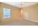Bedroom with neutral walls and carpet features a ceiling fan and a bright window at 2186 Savannah River St, Henderson, NV 89044