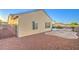 Exterior view showcasing low-maintenance desert landscaping, a covered patio, and charming fire pit at 2186 Savannah River St, Henderson, NV 89044