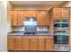 Kitchen with stainless appliances, granite countertops and natural wood cabinets at 2186 Savannah River St, Henderson, NV 89044