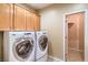 Bright laundry room featuring new washer and dryer, cabinets, and neutral walls at 2186 Savannah River St, Henderson, NV 89044