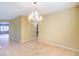 Bright living room with tile flooring, neutral paint and chandelier lighting at 2186 Savannah River St, Henderson, NV 89044