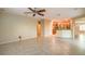 Open-concept living room with a ceiling fan connected to the kitchen and dining area at 2186 Savannah River St, Henderson, NV 89044
