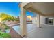 Covered patio area with tiled flooring, desert landscaping, and access to the backyard fire pit at 2186 Savannah River St, Henderson, NV 89044