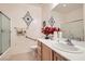 Bright bathroom with vanity, red flower accents, and glass door enclosed shower at 2384 Yellow Bird Ct, North Las Vegas, NV 89084