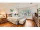 The main bedroom features wood floors, large windows, and a stylish decor at 2384 Yellow Bird Ct, North Las Vegas, NV 89084