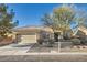 Charming single-story home featuring a two-car garage, xeriscaping, and mature trees at 2384 Yellow Bird Ct, North Las Vegas, NV 89084