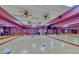 Well-lit fitness room with mirrored walls, hardwood floors, and ample space for various exercises at 2384 Yellow Bird Ct, North Las Vegas, NV 89084