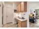 Convenient home office nook with built-in desk, cabinetry, and nearby living space at 2384 Yellow Bird Ct, North Las Vegas, NV 89084