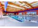 Bright indoor pool area with clear blue water and overhead skylights, creating a refreshing ambiance at 2384 Yellow Bird Ct, North Las Vegas, NV 89084