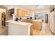Bright open kitchen with an island, breakfast bar, and wood cabinets at 2384 Yellow Bird Ct, North Las Vegas, NV 89084
