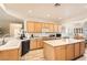 Bright kitchen boasts wood cabinets, tile floors and spacious center island at 2384 Yellow Bird Ct, North Las Vegas, NV 89084