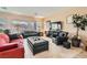 Bright living room featuring tile floors, multiple windows, and comfortable seating at 2384 Yellow Bird Ct, North Las Vegas, NV 89084