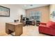 The office features wood floors, a bright window and a comfortable seating area at 2384 Yellow Bird Ct, North Las Vegas, NV 89084