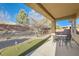 Inviting covered patio with a mini putting green, perfect for outdoor dining and relaxation at 2384 Yellow Bird Ct, North Las Vegas, NV 89084