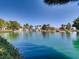Scenic pond with a waterfall, lush greenery, and a playground in the background at 2384 Yellow Bird Ct, North Las Vegas, NV 89084
