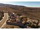 Aerial view of the community showing tile roofs, street, and desert landscape at 2401 Orangeburg Pl, Henderson, NV 89044