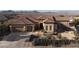 Charming single-story home featuring a well-manicured desert landscape and attached two-car garage at 2401 Orangeburg Pl, Henderson, NV 89044