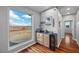 Chic bar area with wine storage and scenic desert views through a large window, perfect for entertaining at 2590 Luke St, Pahrump, NV 89060