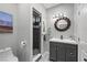 Cozy bathroom featuring gray cabinetry, modern fixtures, and a walk-in shower with designer tile accents at 2590 Luke St, Pahrump, NV 89060