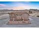 Beautiful two-story home featuring large windows, a stone facade, and a front patio at 2590 Luke St, Pahrump, NV 89060