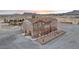 Stunning multi-story home with stone accents, desert landscaping, and mountain views at sunset at 2590 Luke St, Pahrump, NV 89060