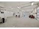 A spacious garage with bright lighting, ample parking space, and multiple garage doors at 2590 Luke St, Pahrump, NV 89060