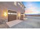 Attached three-car garage with paneled doors and stone accents at 2590 Luke St, Pahrump, NV 89060