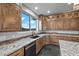 Bright kitchen featuring granite countertops, wooden cabinets, stainless steel appliances, and stunning outdoor views at 2590 Luke St, Pahrump, NV 89060