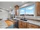 Kitchen counter and sink with gorgeous view of the distant mountains, featuring hardwood floors and stainless appliances at 2590 Luke St, Pahrump, NV 89060