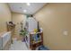 A utilitarian laundry room featuring stacked washer and dryer, storage shelves, and convenient cleaning supplies at 2590 Luke St, Pahrump, NV 89060
