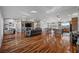 Open concept living room featuring hardwood floors, a fireplace, and a large kitchen at 2590 Luke St, Pahrump, NV 89060