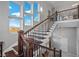 Elegant staircase with wood treads, black iron railings, and large windows providing lots of natural light at 2590 Luke St, Pahrump, NV 89060