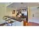 Bright kitchen features a tile breakfast bar, stainless steel appliances, and wood cabinets at 30 Strada Di Villaggio # 521, Henderson, NV 89011