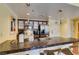 Bright kitchen features a tile breakfast bar, stainless steel appliances, and wood cabinets at 30 Strada Di Villaggio # 521, Henderson, NV 89011