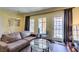 Open-plan living room features neutral walls, modern light fixture and glass furniture at 30 Strada Di Villaggio # 521, Henderson, NV 89011