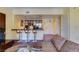 Cozy living room with access to the kitchen and a breakfast bar at 30 Strada Di Villaggio # 521, Henderson, NV 89011