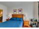 Comfortable main bedroom with ensuite bath features wooden bed frame and matching nightstands at 30 Strada Di Villaggio # 521, Henderson, NV 89011