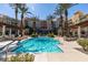 Resort-style swimming pool with palm trees and manicured landscaping enhancing the upscale condo community at 30 Strada Di Villaggio # 521, Henderson, NV 89011
