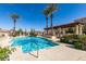 Inviting pool area surrounded by palm trees and lush landscaping at 30 Strada Di Villaggio # 521, Henderson, NV 89011