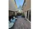 An outdoor patio is furnished with chairs, potted plants and pavers in this backyard scene at 3160 Del Dotto Walk, Henderson, NV 89044