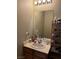 Bathroom featuring a wooden vanity, framed mirror, and toiletries at 3160 Del Dotto Walk, Henderson, NV 89044