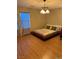 Bright bedroom with wooden floors, contemporary lighting, and a large window at 3160 Del Dotto Walk, Henderson, NV 89044